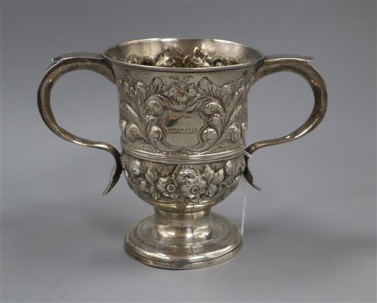 A George III later embossed silver two handled cup (a.f), William & James Priest, London, 1765 15 oz.